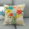 Linen pillow cover with colorful floral bouquet and Live text on a gray fabric sofa - Live Typography with Ocean Elements (5)