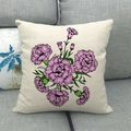 Detailed close-up of colorful floral bouquet linen pillowcase on a grey fabric sofa - Pink and Purple Carnation Illustration (12)