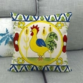 Detail of linen cushion cover with ethnic yellow rooster illustration on gray sofa - Rooster Pattern