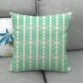 Detailed macro view of beige linen cushion cover with green geometric leaf patterns - Green Geometric Lines