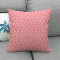 Macro detail of pink geometric linen pillowcase with white V-patterns on a gray sofa - Pink V-Shape Pattern