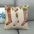 Linen Christmas pillowcase with festive stockings and Merry Christmas text on grey sofa - Christmas Stocking Print Style