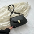 Classic black leather saddle bag with gold buckle and decorative knotted shoulder strap - Black