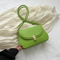 Green faux leather crossbody saddle bag with a golden clasp and knotted shoulder strap - Green