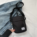 Black Oxford cloth crossbody bag with Hello Weekend label and adjustable strap - Black