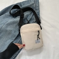 Chic cream nylon crossbody phone bag with Hello Weekend label and wide black strap - White
