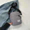 Minimalist grey Oxford cloth crossbody bag with Hello Weekend label and adjustable strap - Gray