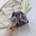 Ethnic geometric woven bucket bag with silver chain strap and pearl drawstring detail - Black