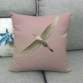 Pink decorative square pillow featuring white bird print on a modern grey fabric sofa - White Egret Style (7)
