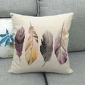 Detail of square linen pillowcase featuring artistic watercolor feather prints on sofa - 45x45cm / Watercolor Painting Four Feathers (12)