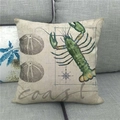 Linen pillowcase featuring a green lobster and compass print on a gray sofa - Lobster Sea Urchin Compass Pattern (1)