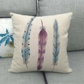 Linen pillowcase with artistic watercolor feathers on a grey fabric sofa - Blue And Purple Vertical Feathers (2)