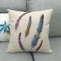 Linen pillow cover with colorful feather print on a gray fabric sofa home setting - Five Colorful Art Feathers (3)