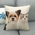 Close-up of linen cushion cover with cat and dog print on a grey sofa in home setting - Yorkshire and Ragdoll Cat
