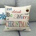 Close-up of linen pillowcase with colorful Christmas greeting typography on gray sofa - Eat Drink Be Merry Style (6)