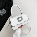 White minimalist crossbody bag with rhinestone buckle and wavy flap design - White