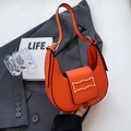 Orange crescent shoulder bag in textured leather with a golden wavy buckle - Orange