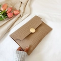 Chic tan crocodile-embossed envelope clutch bag featuring a sleek gold circular buckle - Khaki