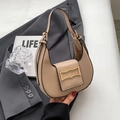 Chic beige crescent underarm bag with gold buckle on a stylish gray suit blazer - Khaki
