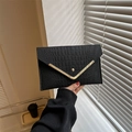 Minimalist black crocodile embossed envelope clutch bag with gold V-shape metal trim - Black