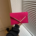 Fuchsia pink envelope clutch bag featuring a crocodile embossed texture and gold V-trim - Rose Red