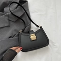 Minimalist black leather underarm bag with a large golden metal buckle for women - Black