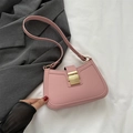 Pink retro faux leather shoulder bag with gold metal buckle on white textured background - Pink