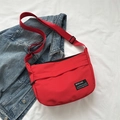 Vibrant red nylon crossbody messenger bag with adjustable strap and black logo detail - Red