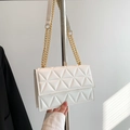 White quilted crossbody bag with gold chain strap and modern geometric triangular stitching - White