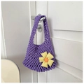 Detail of purple knitted mesh handbag featuring a woven sunflower on a white door - Purple With Pendant