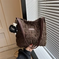 Deep brown tote bag with textured fabric, fringe detail, and plush cartoon pendant - With Pendant / Brown