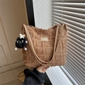 Brown textured fringe tote bag with fuzzy monster charm shown in hand - With Pendant / Khaki