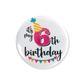 Close-up of it's my 6th birthday button badge with a cartoon party hat and banners - 6th Birthday