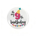 Detail of 9th birthday tinplate badge with colorful hat and banner party decorations - 9th Birthday