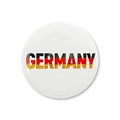 Macro shot of circular Germany badge with national flag colors and glossy finish - GERMANY Text Flag