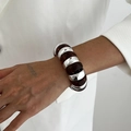 Detail of wide chunky bracelet featuring silver metal and amber resin modular segments - Brown