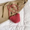 Mini woven bucket bag in vibrant red and white weave with a central pearl closure - Rose Red