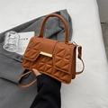 Brown quilted leather handbag with gold metal clasp and a detachable shoulder strap - Brown