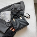Black V-quilted faux leather crossbody bag with woven handle and gold hardware - Black