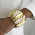 Macro shot of wide stretch bracelet with gold metal and white marble resin segments - White (0124)