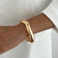 Detail of high-shine gold wave cuff bracelet showing metallic mirror finish on wrist - Irregular Wave Gold Style (02698)