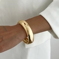 Macro detail of glossy golden chunky cuff bracelet with smooth mirror polished finish - Polished Chunky Round Gold Style (02609)