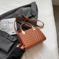 Quilted chevron shoulder bag in caramel brown leather with woven handles and gold hardware - Brown