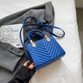 Minimalist square dark blue handbag with V-quilted texture and woven handle design - Blue