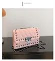 Detailed view of pink quilted leather shoulder bag with gunmetal pyramid studs and chain - Pink
