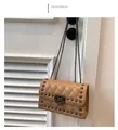 Detail of khaki quilted shoulder bag featuring square metal studs and chain strap on white door - Khaki