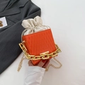 Orange textured bucket bag with cream drawstring and gold chain shoulder strap - Orange