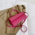 Magenta quilted crossbody bag with gold hardware and top handle on brown blazer - Rose Red