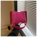 Close-up of rose red faux crocodile leather bag with golden chain and metal buckle - Rose Red
