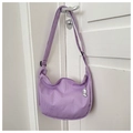 Detail view of purple corduroy crescent bag featuring a soft texture and cute charm - Purple (With Dog Pendant)